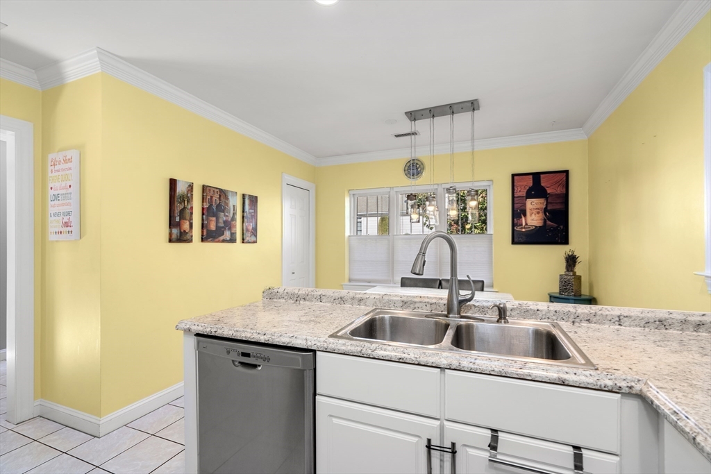 605 Middle Street, Unit 38 Braintree, MA 02184 - Photo 13 of 33 a kitchen with a sink and a refrigerator