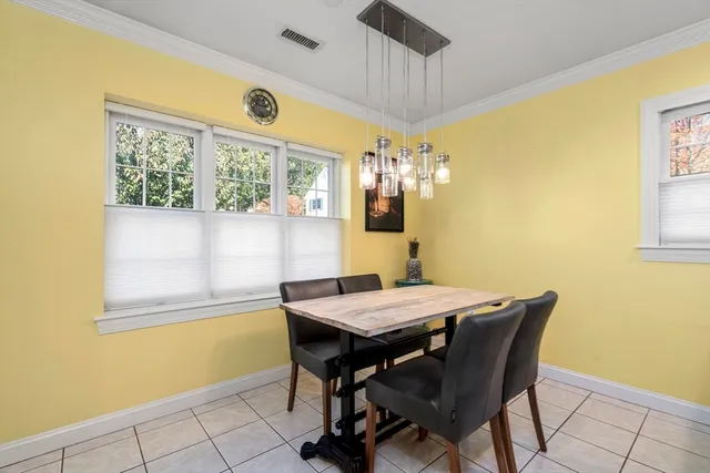 a view of a dining room with a table and chairs