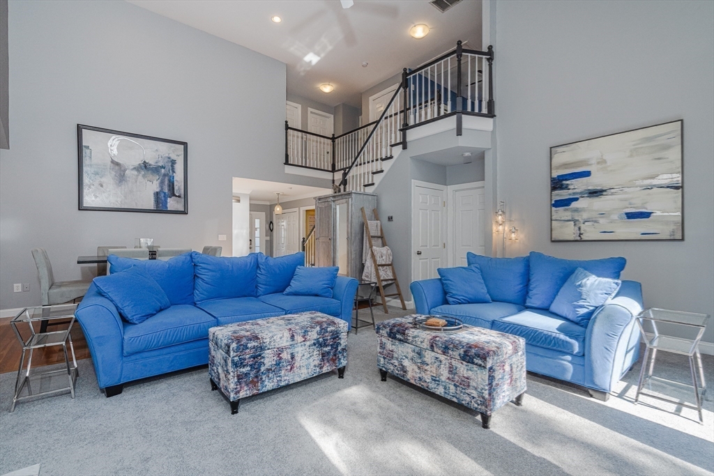 605 Middle Street, Unit 38 Braintree, MA 02184 - Photo 15 of 33 a living room with furniture and a chandelier