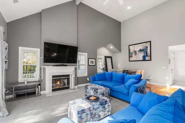 a living room with furniture fireplace and flat screen tv
