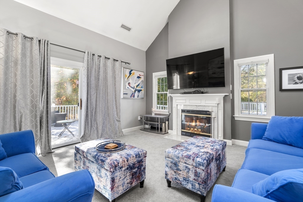 605 Middle Street, Unit 38 Braintree, MA 02184 - Photo 17 of 33 a living room with furniture a flat screen tv and a fireplace