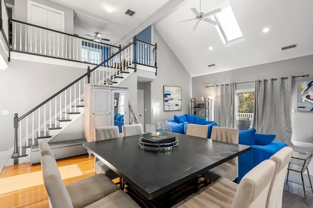 a view of a dining room with furniture a chandelier and wooden floor