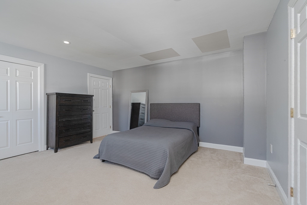 605 Middle Street, Unit 38 Braintree, MA 02184 - Photo 24 of 33 a bedroom with a bed and a bathroom