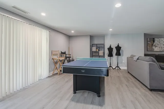 a room with furniture a wooden floor and a window