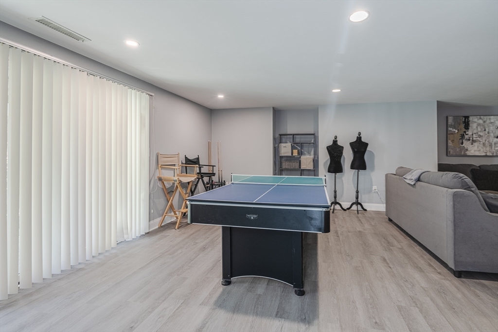 605 Middle Street, Unit 38 Braintree, MA 02184 - Photo 29 of 33 a room with furniture a wooden floor and a window