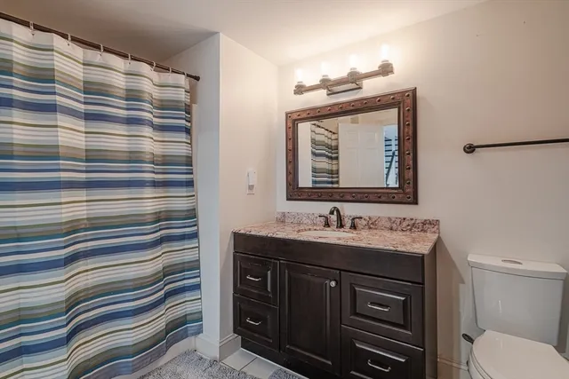 a bathroom with a sink a toilet and mirror