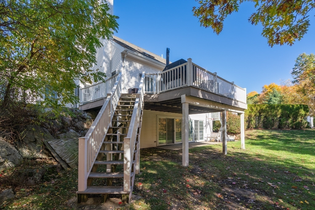 605 Middle Street, Unit 38 Braintree, MA 02184 - Photo 5 of 33 a view of a big house with a small yard and large trees