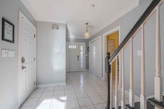 a view of a hallway with entryway and chandelier