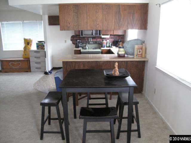 2275 Jester Court Reno, NV 89503 - Photo 3 of 4 a kitchen with a dining table chairs and cabinets