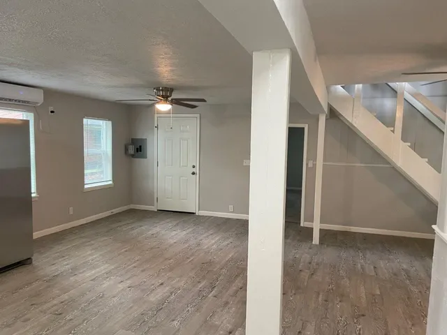 a view of a livingroom with a ceiling fan and window