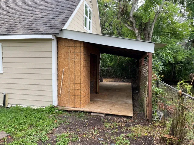 a view of a room with a wooden fence