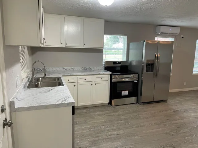 a kitchen with a sink stove and refrigerator