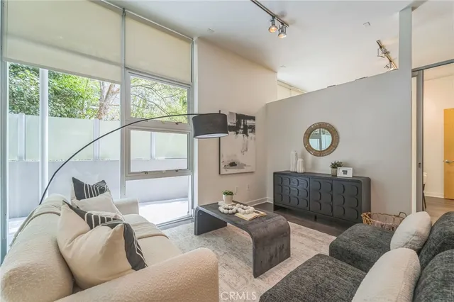 a living room with furniture and a wooden floor