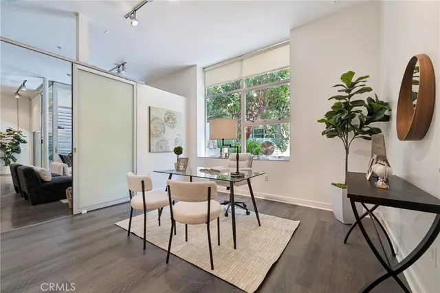 a room with stainless steel appliances kitchen island a dining table and chairs