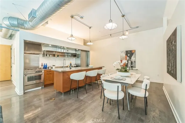 a view of a dining room with furniture wooden floor and a chandelier