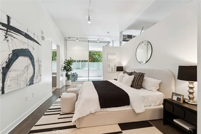 a bedroom with a large bed and a large window