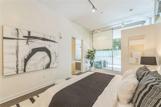 a bedroom with a bed and a mirror