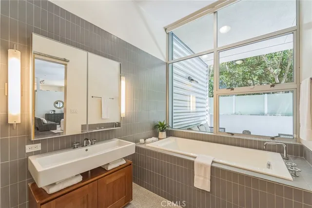 a bathroom with a shower sink and mirror