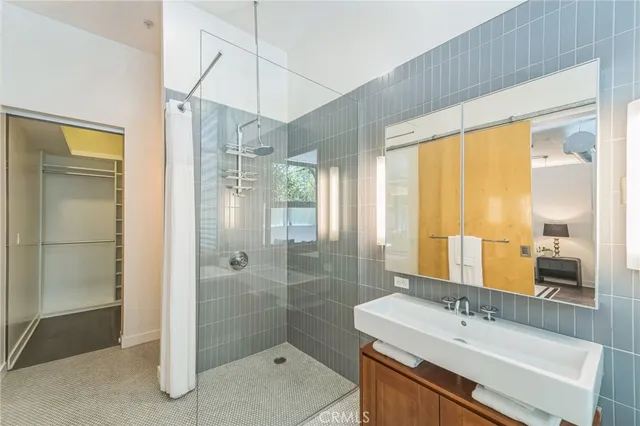 a bathroom with a tub sink and mirror