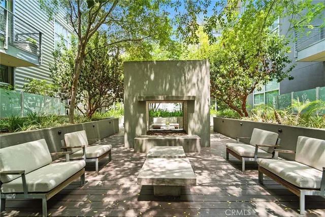 a view of a patio with table and chairs and potted plants
