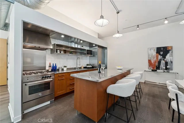 a kitchen with stainless steel appliances a stove a sink and a refrigerator