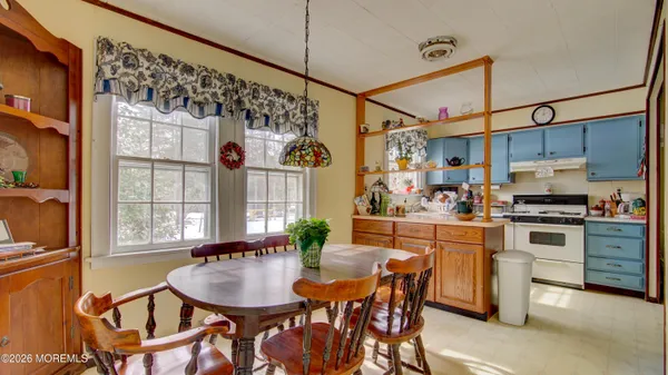 a view of a workspace with furniture and wooden floor