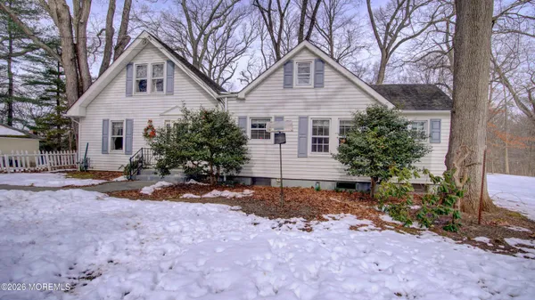 a view of a house with a yard covered with snow in front of house