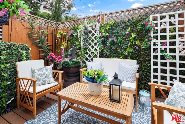 a view of a chairs and table in backyard of the house