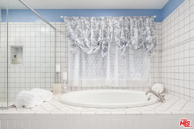 a bathroom with a double vanity sink and a bathtub