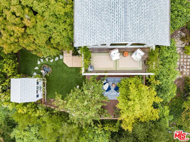 a view of a house with a yard and potted plants