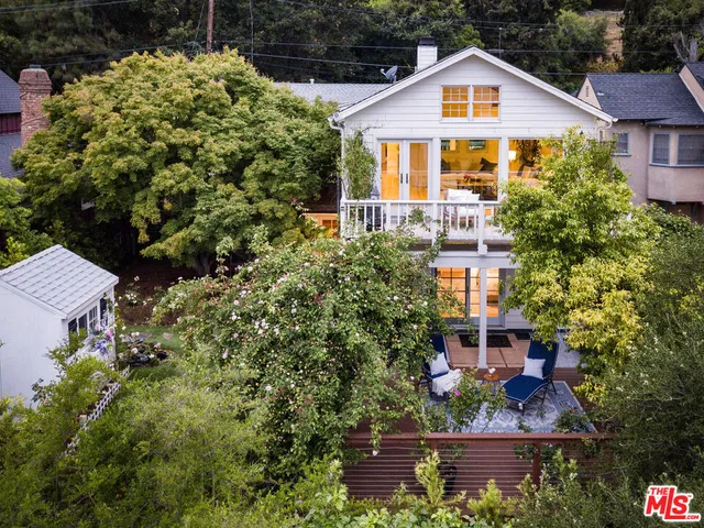 a porch with a bench next to a yard