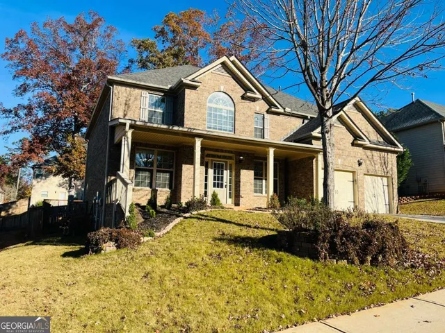a front view of a house with a yard
