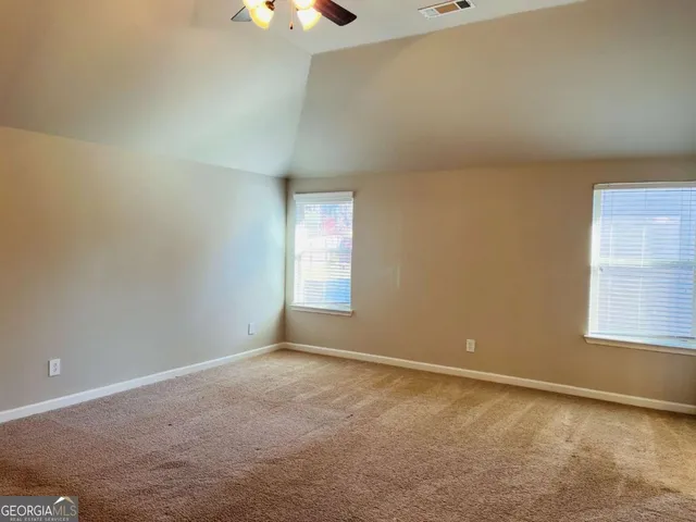 an empty room with windows and entrance