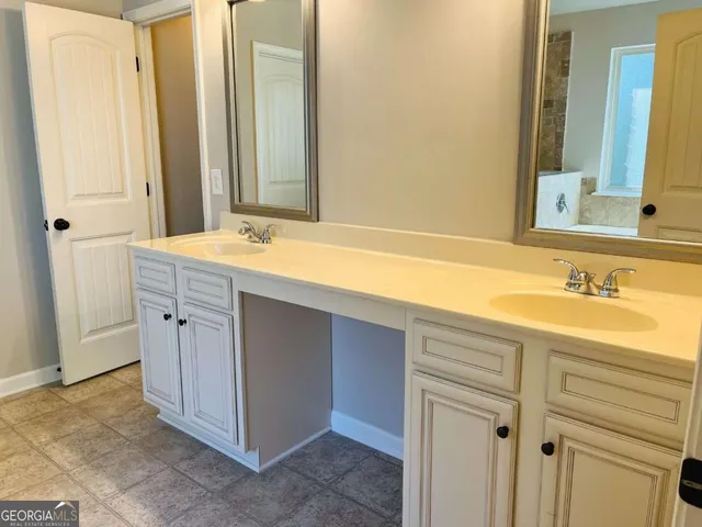 a bathroom with a shower and a sink