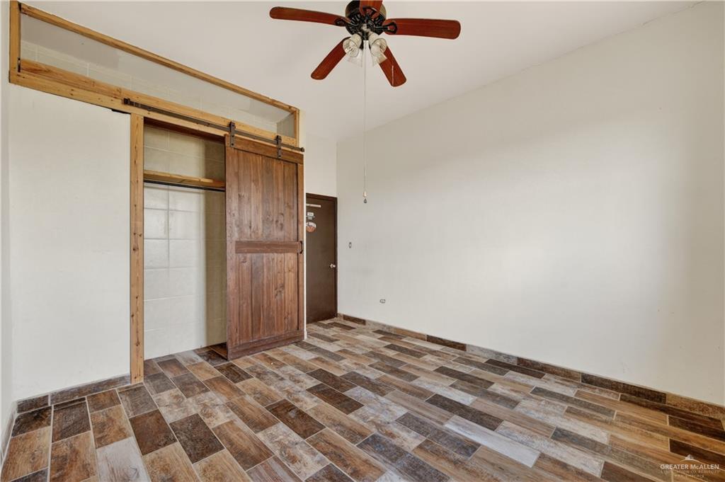 1424 North Sky Soldier Road Weslaco, TX 78596 - Photo 19 of 33 a view of a big room with wooden floor and window