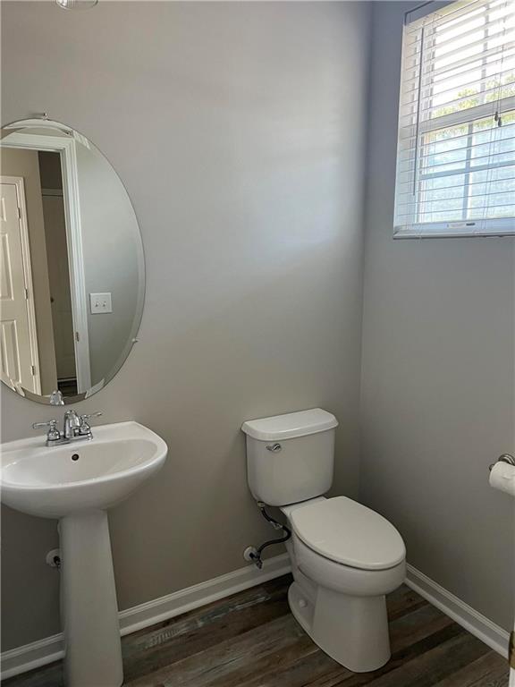 503 Sautee Place Canton, GA 30114 - Photo 6 of 17 a bathroom with a toilet a sink and mirror