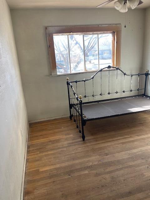 a view of a room with wooden floor and window
