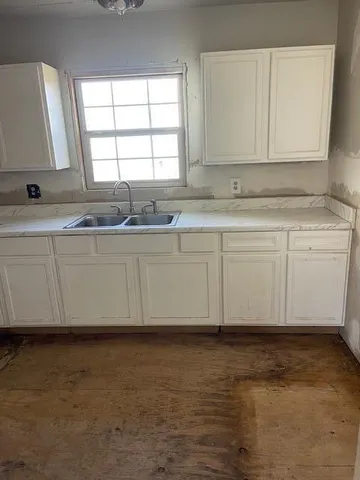 a view of a kitchen with granite countertop cabinets and a sink