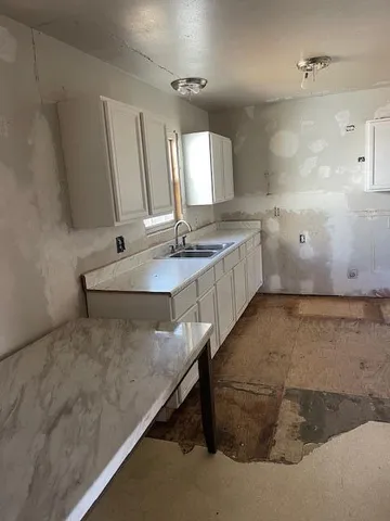 a large bathroom with a tub sink and mirror
