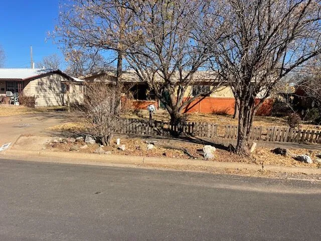 a white house with a snow on the road