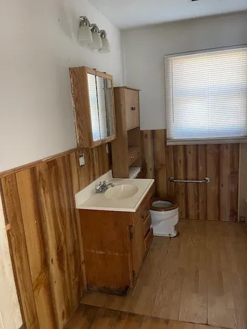a bathroom with a sink a toilet and mirror