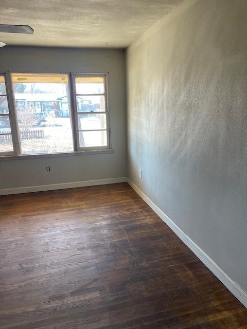 306 52nd Street Lubbock, TX 79404 - Photo 7 of 26 an empty room with wooden floor and windows