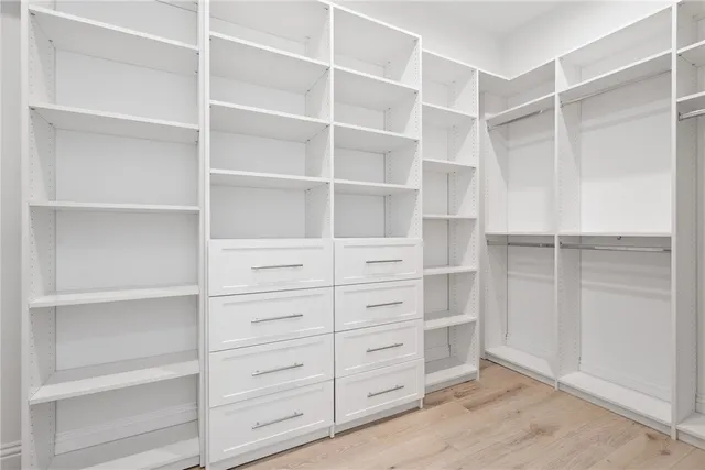 a bathroom with a double vanity sink a toilet a tub and mirror