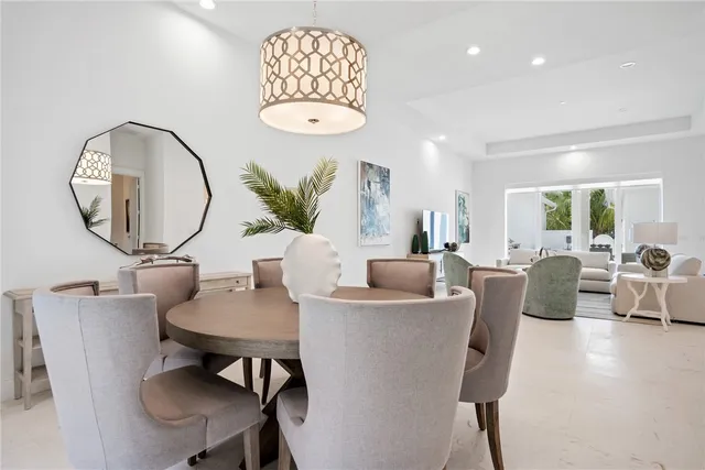 a living room with furniture a table and a large mirror