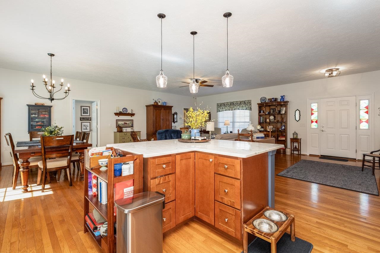 102 Millview Drive Bridgewater, VA 22812 - Photo 14 of 59 a open kitchen with stainless steel appliances granite countertop a stove center island a dining table and chairs with wooden floor