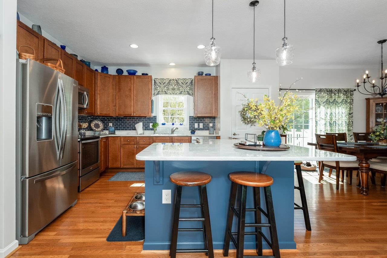 102 Millview Drive Bridgewater, VA 22812 - Photo 19 of 59 a kitchen with stainless steel appliances granite countertop a table chairs sink refrigerator and microwave