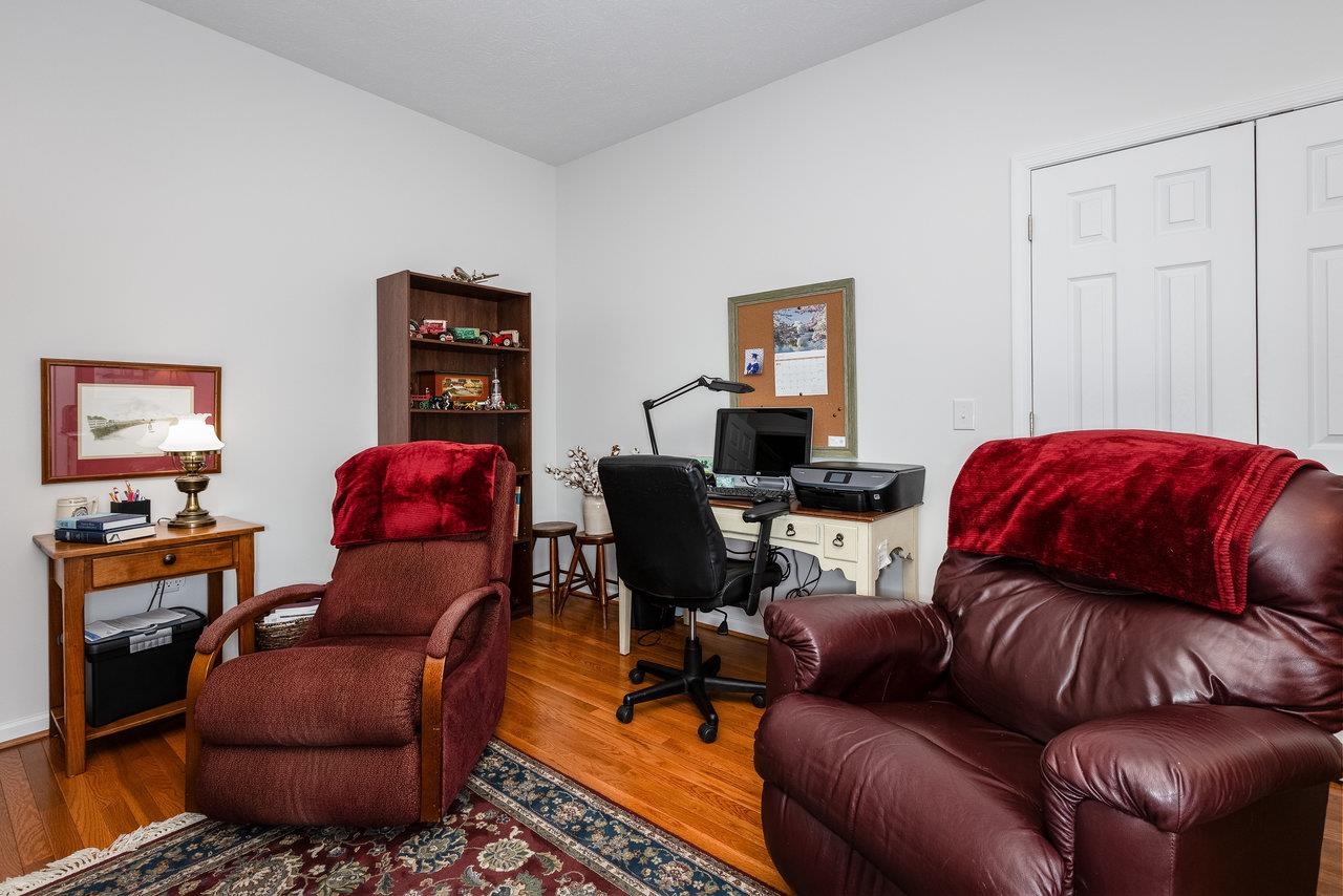 102 Millview Drive Bridgewater, VA 22812 - Photo 31 of 59 a living room with furniture a red chair and a bookshelf