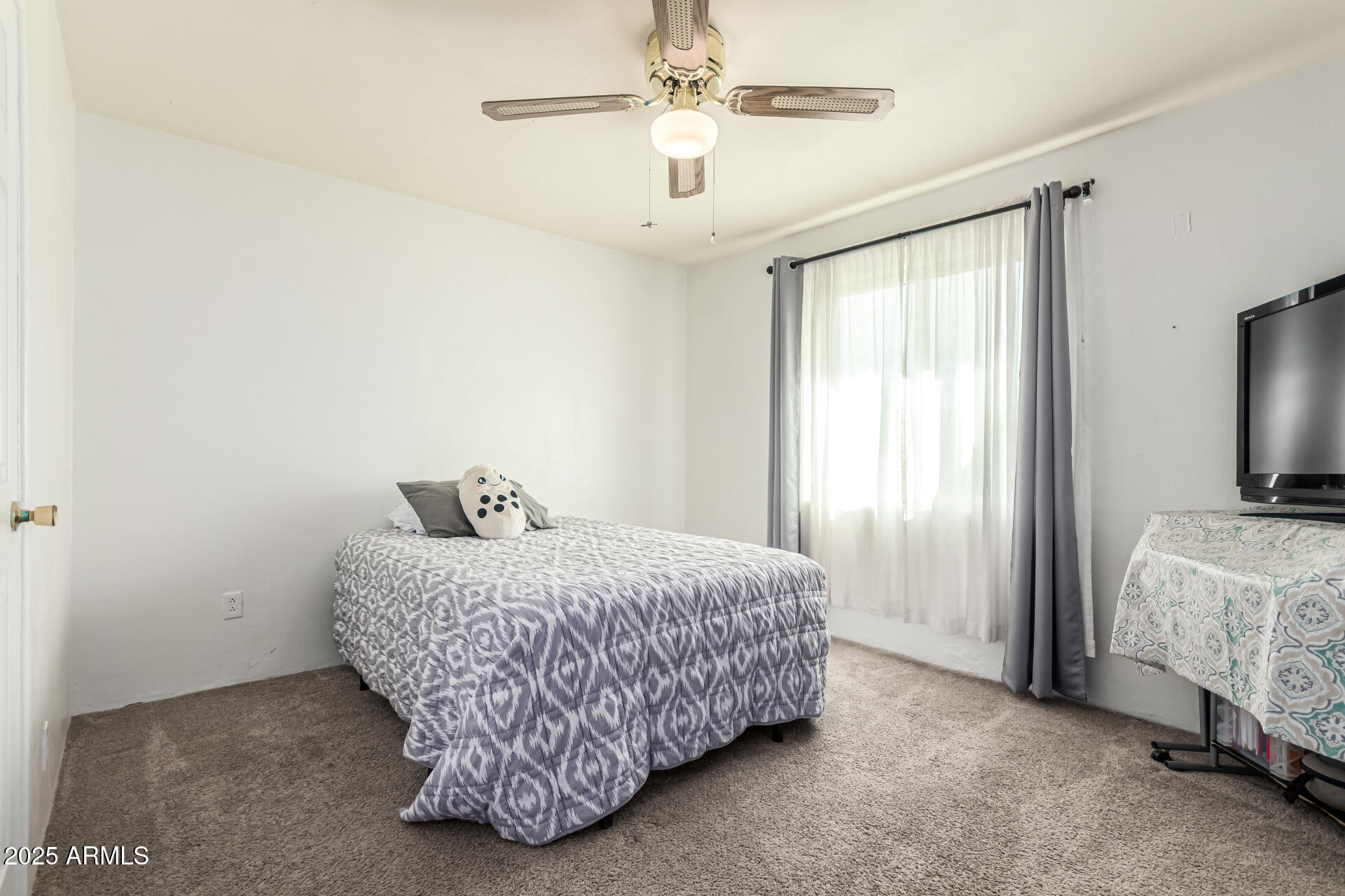 710 East Atlanta Avenue Phoenix, AZ 85040 - Photo 11 of 21 a bedroom with a bed and a chandelier