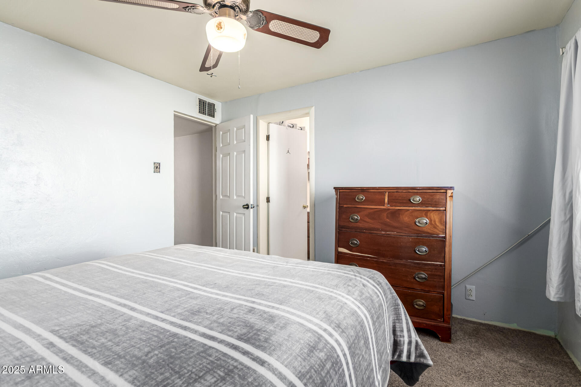 710 East Atlanta Avenue Phoenix, AZ 85040 - Photo 15 of 21 a bedroom with a bed and a chandelier