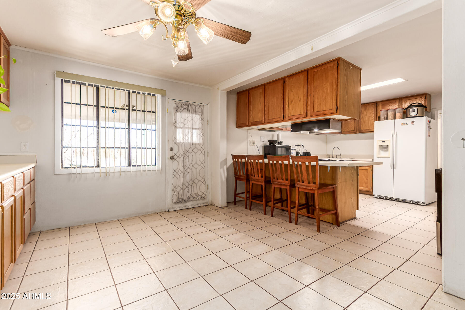 710 East Atlanta Avenue Phoenix, AZ 85040 - Photo 5 of 21 a kitchen with granite countertop a refrigerator a stove top oven a sink a dining table and chairs